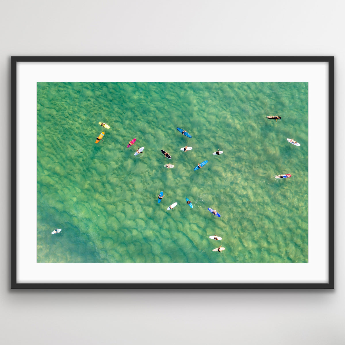 Aerial photograph of surfers scattered across Bondi ocean wall ar